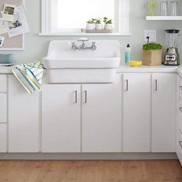 White kitchen with white bib sink.