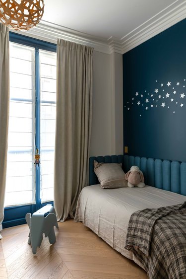 The son's playful blue bedroom.
