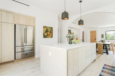 minimalist kitchen island white countertop beige cabinets