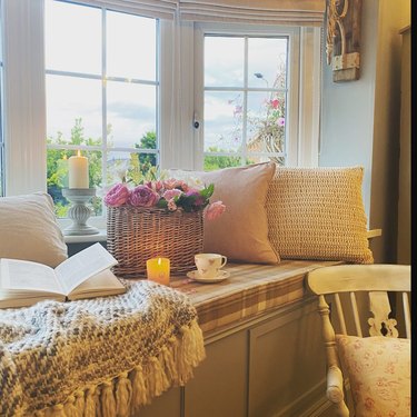 window nook with throw pillows and cozy blanket