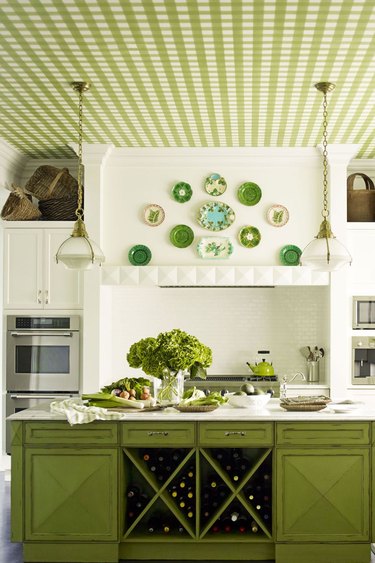 Green kitchen island designed by Mendelson Group