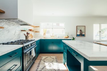 Green kitchen island and open shelves