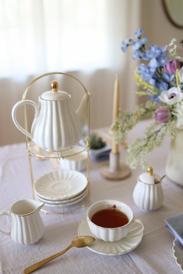 White teapot set with cream and sugar pots and teacup