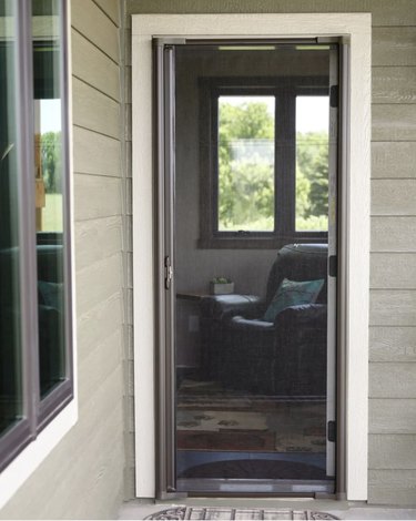 Retractable screen door showing inside of home