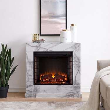 A marble-like portable electric fireplace in a modern living room