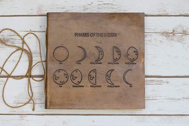 leather journal with moon phase pattern and string