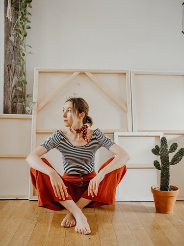 Sofia Shu sitting on floor of art studio