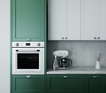green and white kitchen cabinets with oven and stand mixer