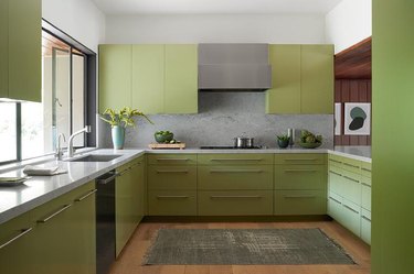 green kitchen cabinets with pale gray walls