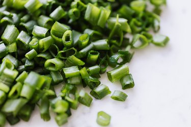 Cut scallions on a white background