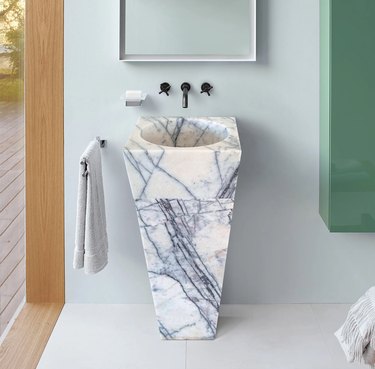 marble pedestal sink in bathroom