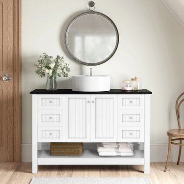 traditional white bathroom vanity with raised sink