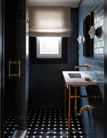 navy floor-to-ceiling tile with black and white floor tiles