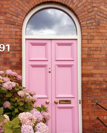 red brick home with pink door