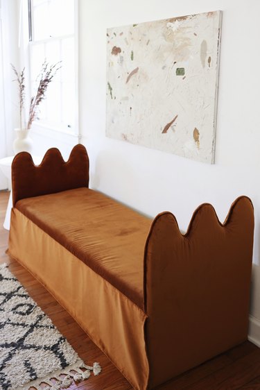 DIY wavy bench daybed with copper velvet fabric with abstract artwork hung above