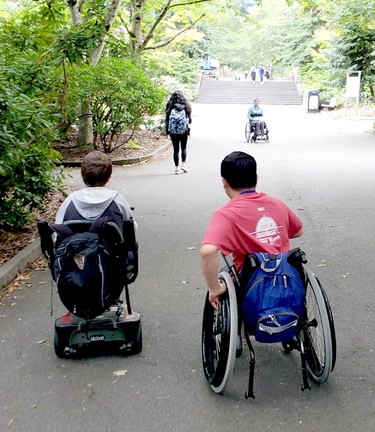 Students in wheelchairs going up an incline at the University of Washington.