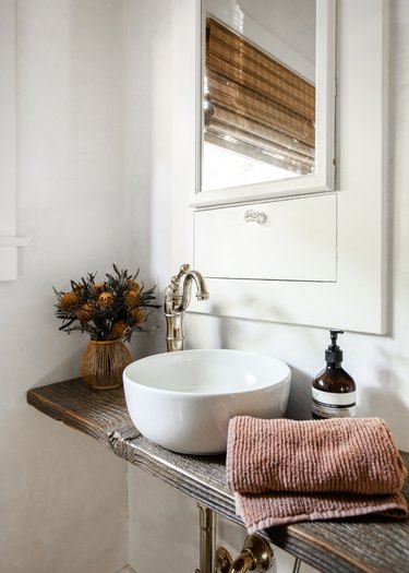 Bathroom vanity with vessel sink, wood vanity, built-in medicine cabinet.