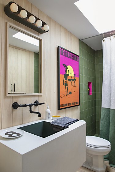bathroom with green shower tile and hot pink accents