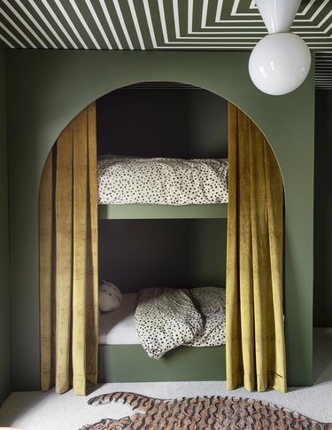 bedroom with hunter green walls and ochre drapes