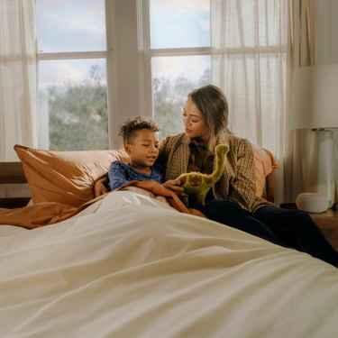 mom and son reading in bed