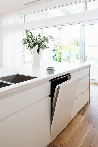 integrated dishwasher in white cabinetry in modern kitchen