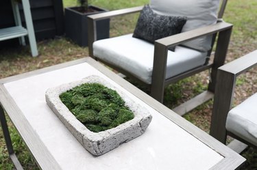 Hypertufa trough filled with moss on outdoor coffee table