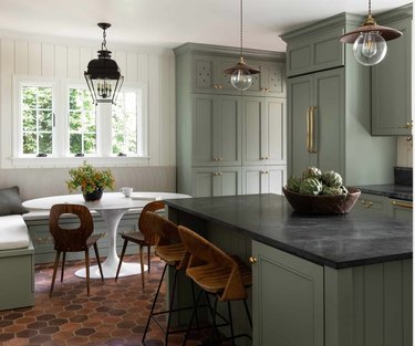 light green kitchen with terracotta flors and banquette
