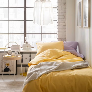 ikea white room with yellow and lavender bedding