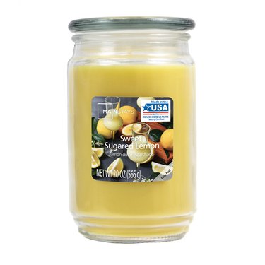 yellow lemon-scented candle in glass jar