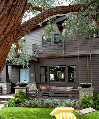 gray-brown craftsman home with blue front door