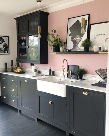 traditional shaker black kitchen cabinets with pink accent wall
