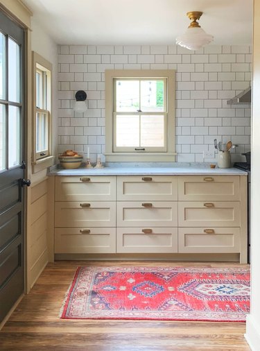 beige kitchen cabinets with white tile backsplash