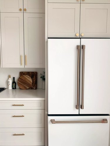 greige kitchen cabinets with white refrigerator