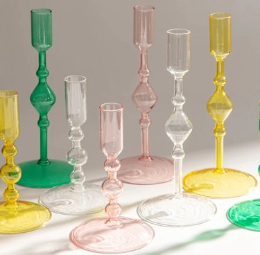 Poketo's Glass Candlestick Holders in green. pink, yellow, and clear