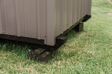 Black paint makes the base of this shed look more finished and modern.