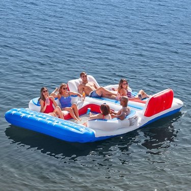 Large water toy with people lounging on it