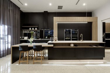 modern black and wood two-tier kitchen island in modern kitchen