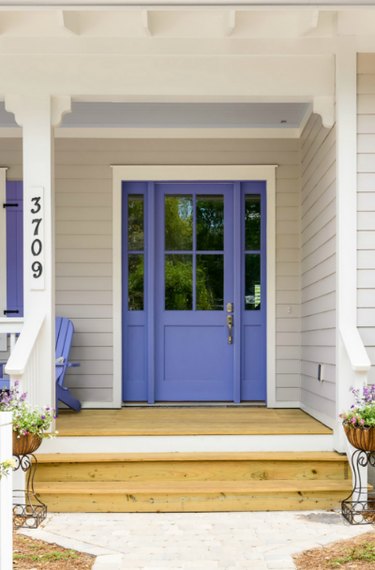 pewter home with purple door and wood decking