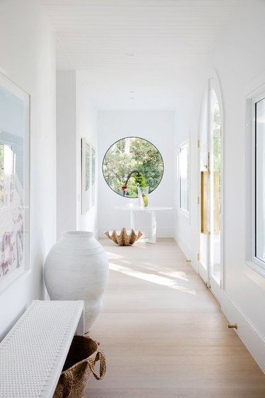 white coastal hallway with circle window