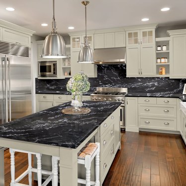 black granite countertop with off white cabinets