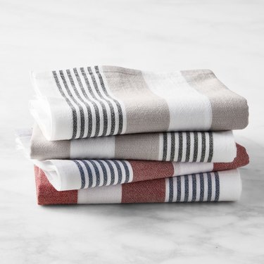 image of four flour sack towels with blue ticking
