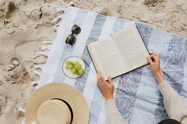 beach towel and book on sand