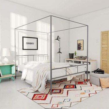 grey canopy bed frame in bedroom