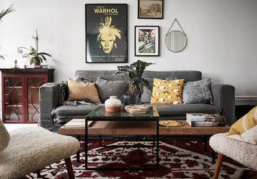 gray sofa with red area rug