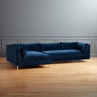 blue sectional sofa near gray wall