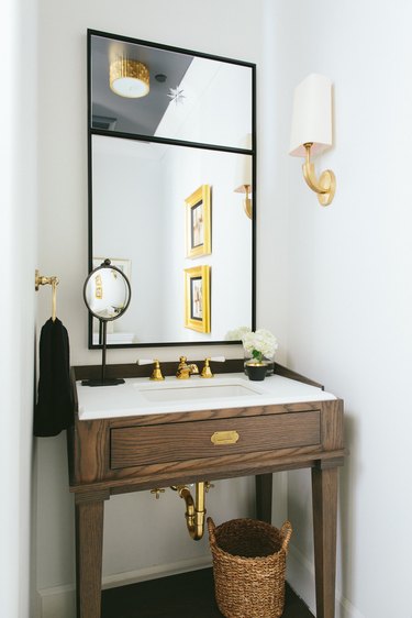 Bathroom vanity with mirror and gold hardware