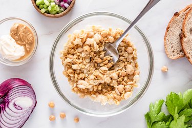 smashed chickpeas in glass bowl