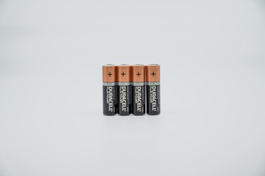 four duracell batteries on white background