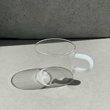 glass tea cup with white handle