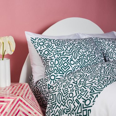 bed with green doodle pattern sheets